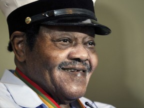 FILE - In this Dec. 20, 2013 file photo, legendary musician Fats Domino is named "Honorary Grand Marshall" of the Krewe of Orpheus, the star-studded Carnival club that traditionally parades the night before Mardi Gras in New Orleans. Domino, the amiable rock 'n' roll pioneer whose steady, pounding piano and easy baritone helped change popular music even as it honored the grand, good-humored tradition of the Crescent City, has died. He was 89. Mark Bone, chief investigator with the Jefferson Parish, Louisiana, coroner's office, said Domino died Tuesday, Oct. 24, 2017. (AP Photo/Doug Parker, File)