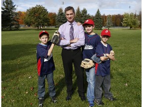 Bruce Murdock, shown with his kids Adam, Jack and Sam at Heritage Park. Bruce is an executive member of Orleans Little League Baseball Association, which wants to install a new, small baseball field at Heritage Park so kids can play. But the league is getting resistance from Coun. Jody Mitic and dog owners.