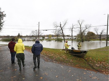 Residents of Parc se la Riviera in Gatineau check out the rising waters caused by record rain fall Monday Oct. 30, 2017. 50 people were evacuated.