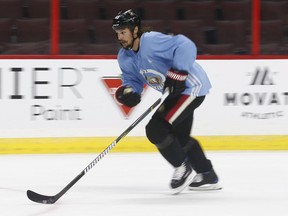 Wearing a blue jersey signifying 'non-contact,' captain Erik Karlsson skates with the Senators during practice last Wednesday.  Tony Caldwell/Postmedia