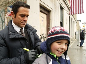 Actor Yannick Bisson, who portrays Toronto police detective William Murdoch, signs autographs for fans during filming scenes for the Canadian TV series Murdoch Mysteries