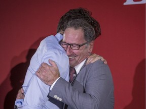 Richard Hebert, Liberal candidate for the byelection in the Lac-Saint-Jean riding, right, hugs Prime Minister Justin Trudeau during a Liberal party rally in Dolbeau-Mistassini, Que, on Thursday, October 19, 2017. Hebert won the byelection Monday night. THE CANADIAN PRESS/Francis Vachon