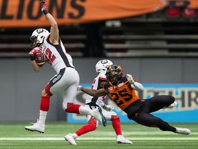 Redblacks receiver Greg Ellingson, left, and Lions defensive back Ronnie Yell collide during the first half of Saturday's game. THE CANADIAN PRESS/Darryl Dyck