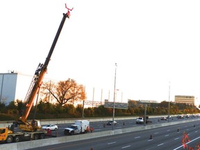 Hydro One strings new cable across Highway 417 Saturday, Oct. 28. Geoff Radnor, Reader photo