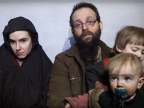 A still image from a video posted by the Taliban on social media on 19 December 2016 shows American Caitlan Coleman, left, speaking next to her husband, Canadian Joshua Boyle, and two sons.