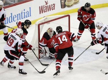 Chris DiDomenico (49) scores the tying goal for the Senators late in the third period of Friday's contest against the Devils. AP Photo/Julio Cortez