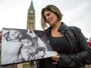 Rachel Quinn, the adoptive mother of Joshua holding a photo of Mary Papatsie, Joshua Papatsie Quinn, with her on the right while attending the 12th annual gathering of the Families of Sisters in Spirit, a group that formed to draw attention to murdered and missing indigenous women.  Photo Wayne Cuddington/ Postmedia
Wayne Cuddington, Postmedia