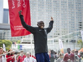 Kenyan runner Philemon Rono cheers on the crowd after winning the Toronto Marathon on Sunday. THE CANADIAN PRESS/Christopher Katsarov