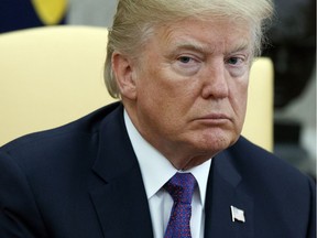 In this Oct. 19, 2017 photo, President Donald Trump listens during a meeting with Governor Ricardo Rossello of Puerto Rico in the Oval Office of the White House in Washington. Trump intends to spend at least $430,000 of his own money to help pay the legal bills of White House staff and campaign aides related to the investigations into Russian election meddling in the 2016 election. A White House official confirmed the plan, which was first reported by the website Axios.  (AP Photo/Evan Vucci, File) ORG XMIT: NY506

OCT. 19, 2017 FILE PHOTO
Evan Vucci, AP