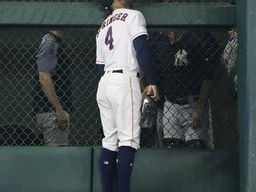 Houston Astros' George Springer looks up at New York Yankees' Todd Frazier's ground rule double stuck in the fence during the fifth inning of Game 2 of baseball's American League Championship Series Saturday, Oct. 14, 2017, in Houston. (AP Photo/David J. Phillip)