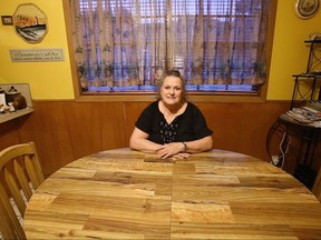 Joyce Ewing, 69, sits at the kitchen table in her home in Port Neches, Texas, on Thursday, Sept. 21, 2017. Ewing, a staunch Trump supporter, does not believe humans have much impact on climate change. She also agrees with President Trump's moves to loosen environmental restrictions on U.S. businesses. "Whatever it takes to bring industry back should be done," she says, emphatically. (AP Photo/Martha Irvine)
