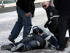 City police officers arrest a suspected drug trafficker in front of City Centre Mall downtown in Edmonton Ab on Thursday Mar. 3, 2011. Police say they have noticed a problem in the area are are working to fix the problem.