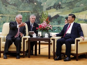 U.S. Secretary of State Rex Tillerson, left, chats with China's President Xi Jinping during a meeting at the Great Hall of the People in Beijing, Saturday, Sept. 30, 2017.