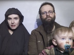 In this file image from video released by Taliban Media in December 2016, Caitlan Coleman talks in the video while her Canadian husband Joshua Boyle holds their two children. The couple and their three children were rescued Wednesday, Oct. 12, 2017, five years after the couple was abducted in Afghanistan on a backpacking trip. The children were born in captivity.