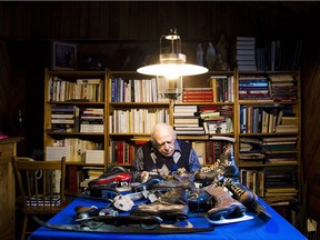 Jean-Marie Leduc sits with some of the more than 350 pairs of skates in his collection.
