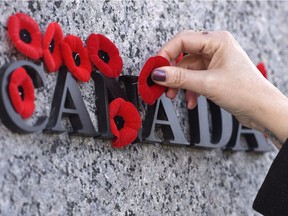 People placed poppies on the National War Memorial during the Remembrance Day ceremony last year.