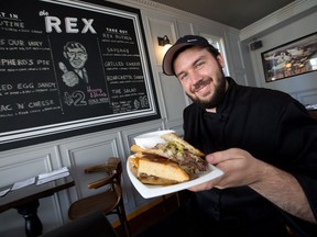 Cody Starr, chef at The Rex on Adeline St in Little Italy, with "The Rex Reuben" sandwich in July 2014.