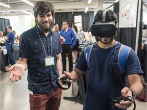 Alex Imray Papineau, left, presents his VR technology, Masterpiece VR/Exchange Integration, during the presentation for Applied Research Day at the Bayview Innovation Yards in Ottawa Friday, August 18, 2017. (Darren Brown/Postmedia)