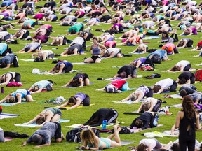 Wednesday lunch-hour yoga sessions draw hundreds to Parliament Hill.