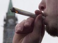A man lights a marijuana joint as he participates in the 4/20 protest on Parliament Hill in Ottawa, April 20, 2015.