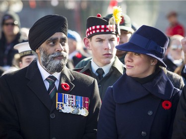 Sophie Gregoire Trudeau, wife of Prime Minister Justin Trudeau along with Minister of National Defence Harjit Sajjan watch the march during the National Remembrance Day Ceremony at the National War Memorial in Ottawa on Saturday, November 11, 2017.