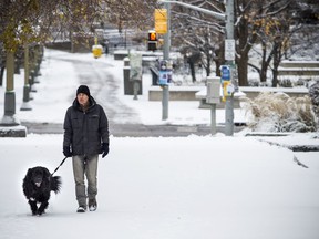 Daniel Wright walks along with the very happy Porter who was all smiles about the blanket of snow Ottawa woke up to Sunday November 19, 2017.