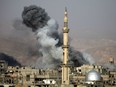 Smoke rises following an air strike on the rebel-held besieged town of Arbin, in the Eastern Ghouta region on the outskirts of Damascus, on November 18, 2017.