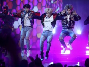 BTS performs the song DNA during the American Music Awards at Los Angeles on Sunday night.  Matt Sayles/Invision/AP