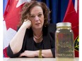 MPP Lisa MacLeod with a bottle of discoloured water from Lynnwood Gardens last March.