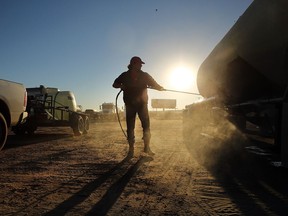 A truck used to carry sand for fracking is washed in a truck stop on February 4, 2015 in Odessa, Texas. Fracking, writes Greg Allen, risks dramatically increasing methane in the atmosphere. We should stop the amount of methane released. (Spencer Platt/Getty Images)