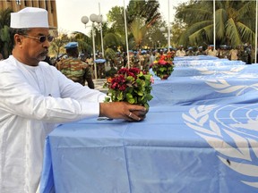 Modern-day peacekeeping can be a dangerous business. Here, the Chadian head of the UN force in Mali lays flowers on a coffin covered with UN flag in 2016 during a tribute to seven Guinean peacekeepers killed in an Islamist attack in northeastern Mali. / AFP / HABIBOU KOUYATEHABIBOU KOUYATE/AFP/Getty Images