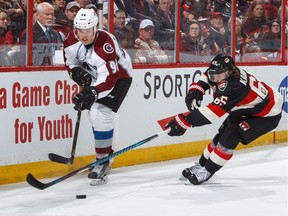 Mikko Rantanen #96 of the Colorado Avalanche controls the puck against Erik Karlsson #65 of the Ottawa Senators during an NHL game at Canadian Tire Centre on March 2, 2017.