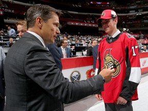 Drake Batherson meets with coach Guy Boucher after being selected 121st overall by the Ottawa Senators during the 2017 NHL Draft at the United Center on June 24, 2017 in Chicago, Illinois.