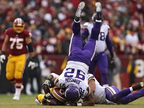 Running back Chris Thompson #25 of the Washington Redskins is tackled by defensive tackle Tom Johnson #92 of the Minnesota Vikings during the fourth quarter at FedExField on November 12, 2017 in Landover, Maryland.
