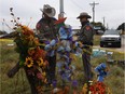 State troopers check a memorial outside the First Baptist Church, which was the scene of the shooting that killed 26 people in Sutherland Springs, Texas on Nov. 8, 2017. / AFP PHOTO / MARK RALSTONMARK RALSTON/AFP/Getty Images