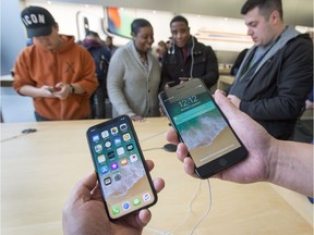 The new iPhone X, left, and the iPhone 8 are seen at the Apple store Friday, November 3, 2017 in Montreal.