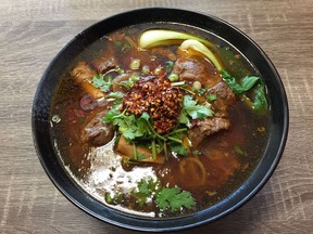 Taiwanese beef  noodle soup with a dollop of chili condiment at  Spicy House- pic by Peter Hum   Ottawa Citizen Photo Email