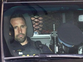 Basil Borutski (rear) leaves in a police vehicle after appearing at the courthouse in Pembroke, Ont. on Wednesday, Sept. 23, 2015.
