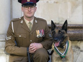 Corporal Daniel Hatley poses for a photo Friday Nov. 17, 2017, with his Military Working Dog, Mali, who was named as recipient of the Dickin Medal for animal bravery after Mali helped save the lives of troops in Afghanistan. The PDSA Dickin Medal is the animal equivalent of the Victoria Cross presented in recognition of bravery.  The  PDSA veterinary charity says Mali was twice sent through direct fire to conduct searches for explosives and detected the presence of insurgents, giving troops key seconds to "engage the enemy in close-quarter combat." (Naomi Gabrielle/PDSA via AP) ORG XMIT: LON809

AP PROVIDES ACCESS TO THIS THIRD PARTY PHOTO SOLELY TO ILLUSTRATE NEWS REPORTING OR COMMENTARY ON FACTS DEPICTED IN IMAGE; MUST BE USED WITHIN 14 DAYS FROM TRANSMISSION; NO ARCHIVING; NO LICENSING; MANDATORY CREDIT
Naomi Gabrielle, AP
