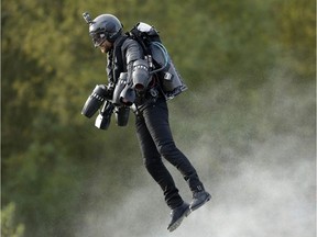Richard Browning sets the Guinness World Record for 'the fastest speed in a body-controlled jet engine power suit', at Lagoona Park in Reading, England, Thursday, Nov. 9, 2017. A British inventor billed as a real-life version of the superhero Iron Man has hit the fastest speed in a body-controlled jet engine power suit at 32 mph (51 kph) to set a new Guinness world record. The record keeper announced Tuesday's feat on Thursday as part of its annual Guinness World Records day. (Tim Ireland/PA via AP) ORG XMIT: LON821

UNITED KINGDOM OUT  NO SALES  NO ARCHIVE  PHOTOGRAPH CANNOT BE STORED OR USED FOR MORE THAN 14 DAYS AFTER THE DAY OF TRANSMISSION
Tim Ireland, AP