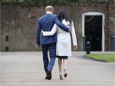 Britain's Prince Harry and Meghan Markle walk away after posing for the media in the grounds of Kensington Palace in London, Monday Nov. 27, 2017. It was announced Monday that Prince Harry, fifth in line for the British throne, will marry American actress Meghan Markle in the spring, confirming months of rumors. (AP Photo/Alastair Grant) ORG XMIT: TH124
Alastair Grant, AP