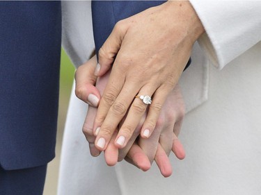 Meghan Markle wears her engagement ring as she poses with Britain's Prince Harry for the media in the grounds of Kensington Palace in London, Monday Nov. 27, 2017. It was announced Monday that Prince Harry, fifth in line for the British throne, will marry American actress Meghan Markle in the spring, confirming months of rumors. (Dominic Lipinski/PA via AP) ORG XMIT: LON831

UNITED KINGDOM OUT  NO SALES  NO ARCHIVE  PHOTOGRAPH CANNOT BE STORED OR USED FOR MORE THAN 14 DAYS AFTER THE DAY OF TRANSMISSION
Dominic Lipinski, AP