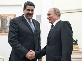 Russian President Vladimir Putin, right, shakes hands with Venezuela's President Nicolas Maduro during their meeting at the Kremlin in Moscow, Russia, on October 4, 2017. Canada is taking aim at corruption and rights abuses in Russia, Venezuela and South Sudan by imposing targeted sanctions on 52 individuals, including Venezuelan President Nicolas Maduro. It is the first use of the Justice for Victims of Corrupt Foreign Officials Act, a so-called Magnitsky law which won final approval in Parliament two weeks ago. THE CANADIAN PRESS/AP, Yuri Kadobnov ORG XMIT: CPT128

EDS NOTE A FILE PHOTO
Yuri Kadobnov,