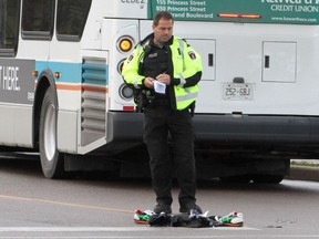 Police investigate the scene of a fatal collision involving a pedestrian and a city bus Friday, Nov. 3.