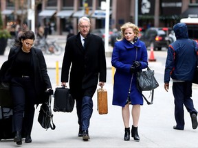 Laura Miller, second right, deputy chief of staff to former Ontario premier Dalton McGuinty, arrives with her lawyer Scott Hutchison for closing arguments at court in Toronto on Wednesday, Nov. 22, 2017. Miller and her boss, David Livingston, are accused of illegally destroyed documents related to the government's decision to cancel two gas plants in 2011. THE CANADIAN PRESS/Colin Perkel