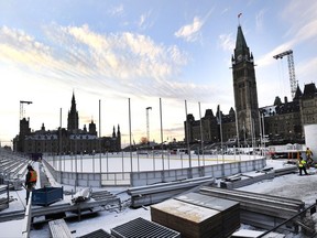 Construction continues on the skating rink on Parliament Hill in Ottawa on Monday, Nov. 20, 2017. The rink is part of a $5.6 million budget that includes a contest to bring 32 peewee house league hockey teams from across the country to Ottawa for a tournament after Christmas. The rink comes complete with cooling system, grandstands and boards. But outside of the tournament and a few other assorted events, there will be no hockey allowed on the ice. Also no food, no rough housing, no tag, no figure or speed skating, and no carrying of children.