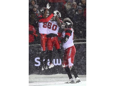Calgary Stampeders slotback Kamar Jorden, left, celebrates his touchdown with wide receiver Marken Michel (80) and Calgary Stampeders offensive lineman Dan Federkeil during first half CFL football action in the 105th Grey Cup on Sunday November 26, 2017 in Ottawa.