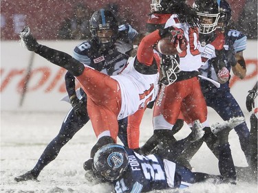Calgary Stampeders quarterback Bo Levi Mitchell (19) is hit by Toronto Argonauts defensive back Qudarius Ford (21) during first half CFL football action in the 105th Grey Cup on Sunday, November 26, 2017 in Ottawa.