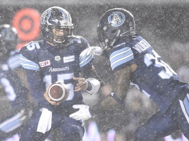 Toronto Argonauts quarterback Ricky Ray (15) hands the ball off to Toronto Argonauts running back James Wilder Jr. (32) during first half CFL football action against the Calgary Stampeders in the 105th Grey Cup Sunday November 26, 2017 in Ottawa.