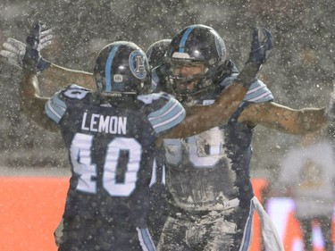 Toronto Argonauts defensive lineman Cleyon Laing (90) celebrates a quarterback sack with defensive lineman Shawn Lemon (40) during first half CFL football action against the Calgary Stampeders in the 105th Grey Cup Sunday November 26, 2017 in Ottawa.